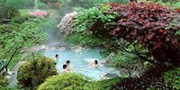 Four people enjoying a hot spring
