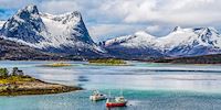 Boats and snowy mountains near Narvik, Norway