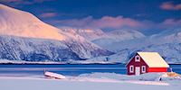 Red home among the arctic snowscape in Tromsø, Norway